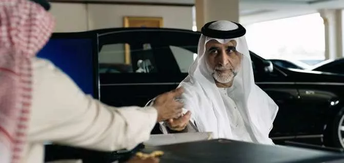 Man in traditional dress in car